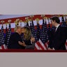 Republican presidential nominee and former U.S. President Donald Trump hugs his wife Melania, as they stand next to and Barron Trump, at Donald Trump's rally at the Palm Beach County Convention Center