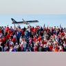 Supporters watch as Republican presidential nominee, former President Donald Trump lands before a campaign rally at Kinston Regional Jetport
