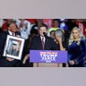 Republican presidential nominee and former President Donald Trump holds a portrait of Nicholas Douglas Quets