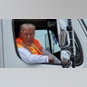 Republican presidential nominee former President Donald Trump talks to reporters as he sits in a garbage truck