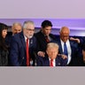 People pray with Republican presidential nominee, former President Donald Trump during a roundtable discussion at the Latino Summit held at Trump National Doral Golf Club
