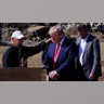Republican presidential nominee and former President Donald Trump prays with Mike Stewart as he visits a site damaged by Hurricane Helene