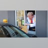 Republican presidential nominee and former President Donald Trump works the drive-through line during a campaign photo op as he visits a McDonald's restaurant