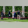 Law enforcement officials work at the crime scene outside the Trump International Golf Club