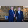 Former US President Donald Trump shakes hands with Israeli Prime Minister Benjamin Netanyahu as they pose for a photo within their meeting at Mar-a-Lago estate