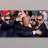 Republican presidential candidate and former President Donald Trump is assisted by the Secret Service after gunfire rang out during a campaign rally