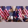 Former President Donald Trump stands onstage with his wife, former first lady Melania Trump, after announcing that he will once again run for U.S. president