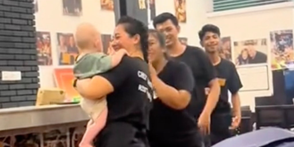 Restaurant staff watch baby so parents can eat meals in peace