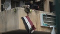Syrian opposition fighters remove a government Syrian flag from an official building in Salamiyah, east of Hama, Syria Syria, Saturday Dec. 7, 2024. - Fox News