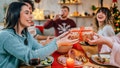 People exchange Christmas gifts over food. - Fox News