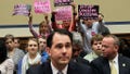 Members of Code Pink (L-R) Medea Benjamin, Liz Hourican and Tighe Barry, hold signs to protest as Wisconsin Gov. Scott Walker (C) takes his seat during a hearing before the House Oversight and Government Reform Committee April 14, 2011 on Capitol Hill in Washington, DC. The hearing was to examine the fiscal problems faced by states and municipalities and the role of federal government on dealing with those problems. (Photo by Alex Wong/Getty Images) - Fox News