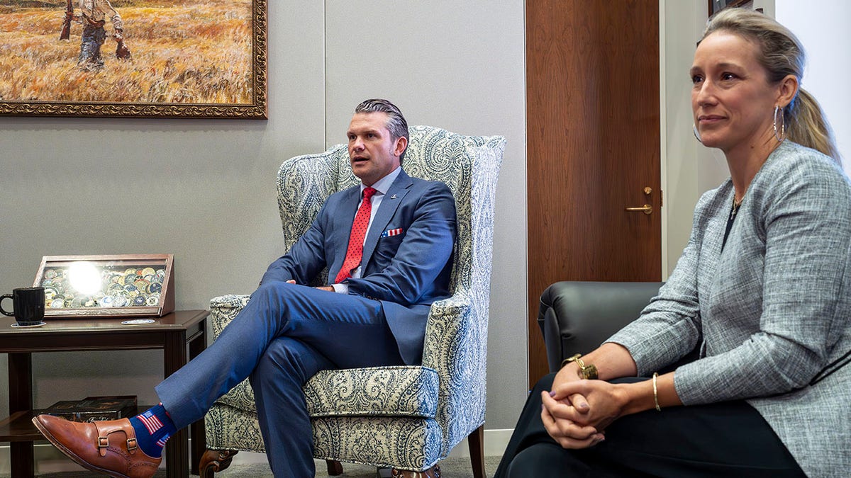 Pete Hegseth, President-elect Donald Trump's nominee for Secretary of Defense, left, joined by his wife Jennifer Hegseth, attends a meeting with Senator Mike Rounds, a member of the Senate Armed Services Committee, at the Capitol in Washington, Thursday, December 5, 2024. (AP Photo/ J.Scott Applewhite)