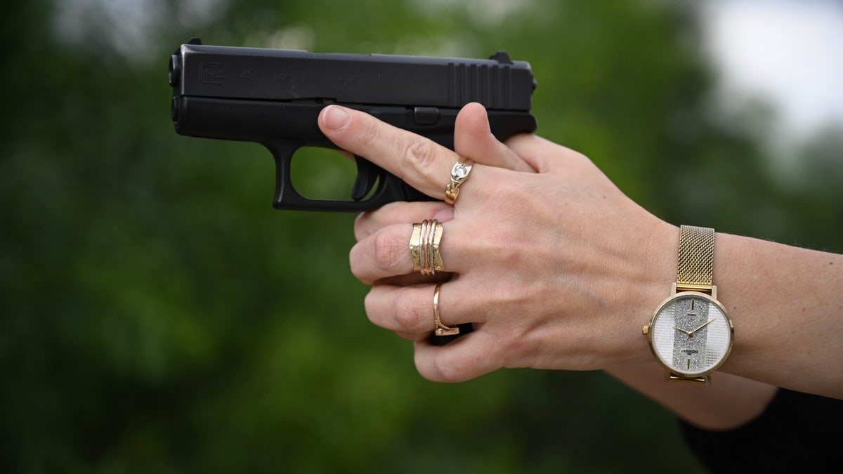 Woman aiming a gun