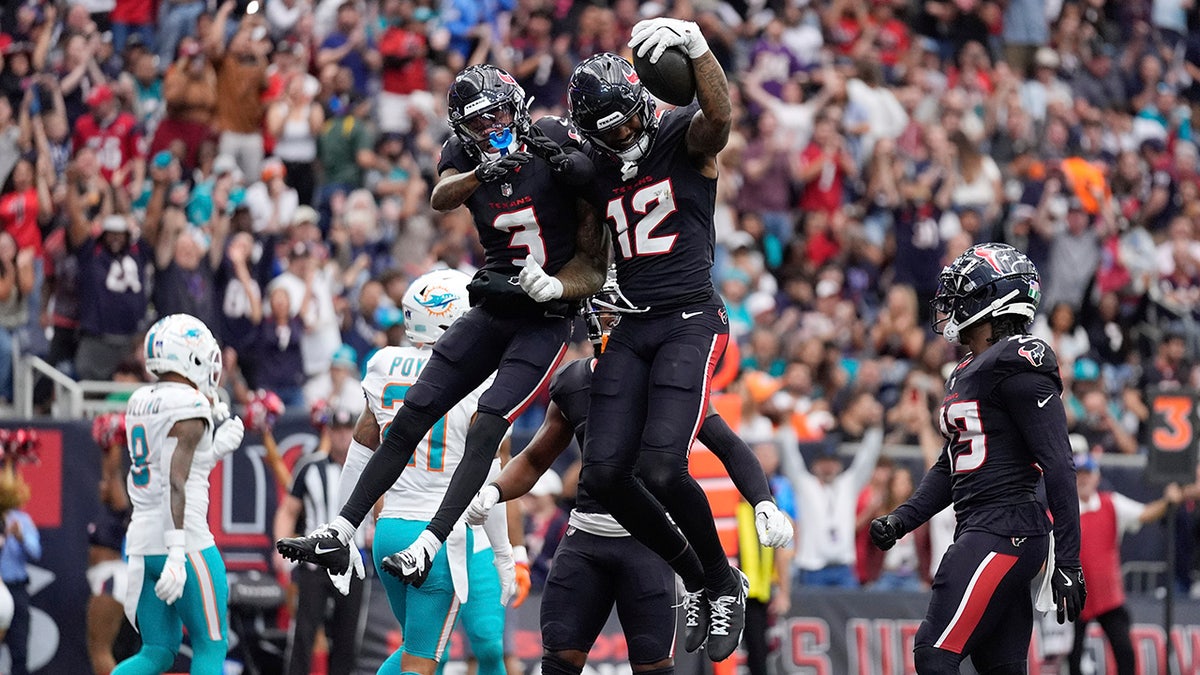 Nico Collins celebrates with Tank Dell