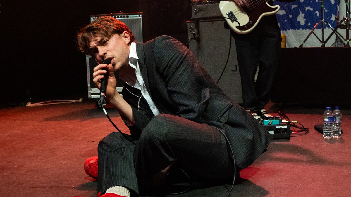 Alex Rice sings into the microphone