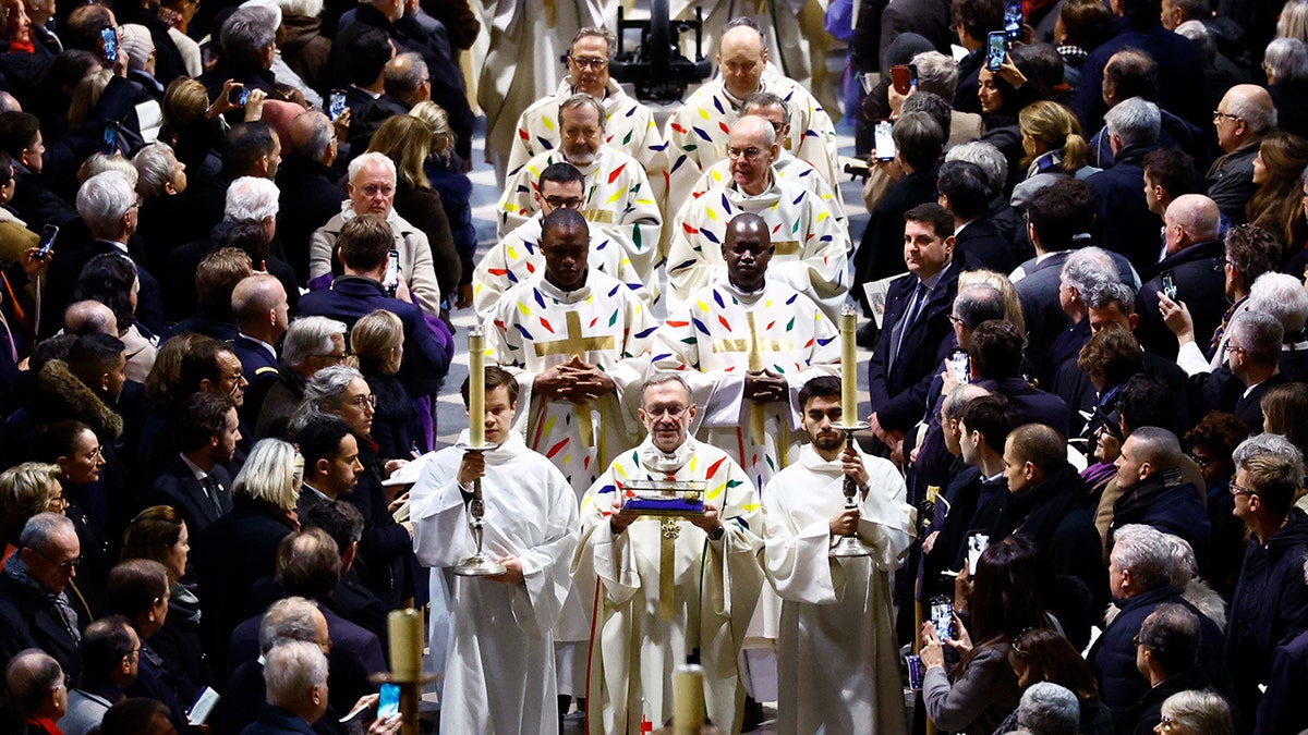 Priest and clergy arrive for mass
