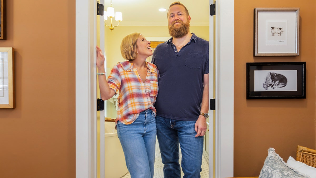 Erin and Ben Napier pose in a remodeled house