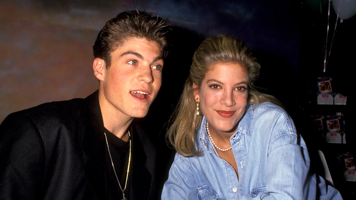 Brian Austin Green and Tori Spelling posing together in the 1990s