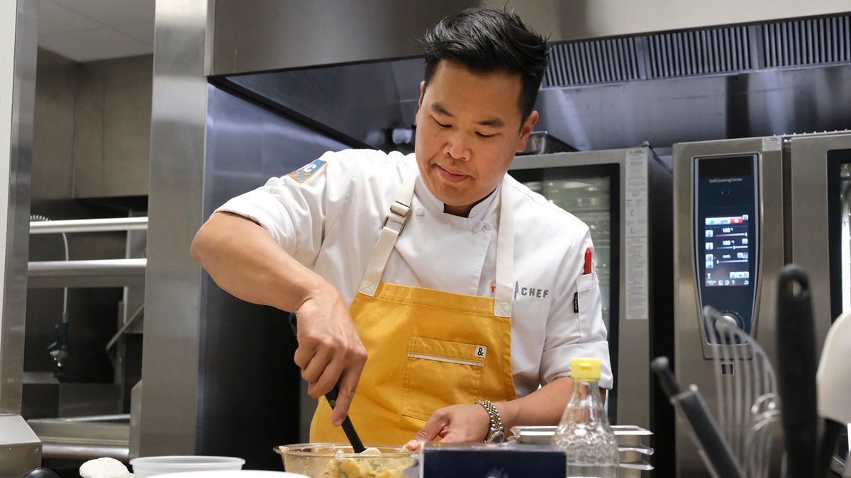 Buddha Lo prepares a dish during the final episode of "Top Chef" in 2022.