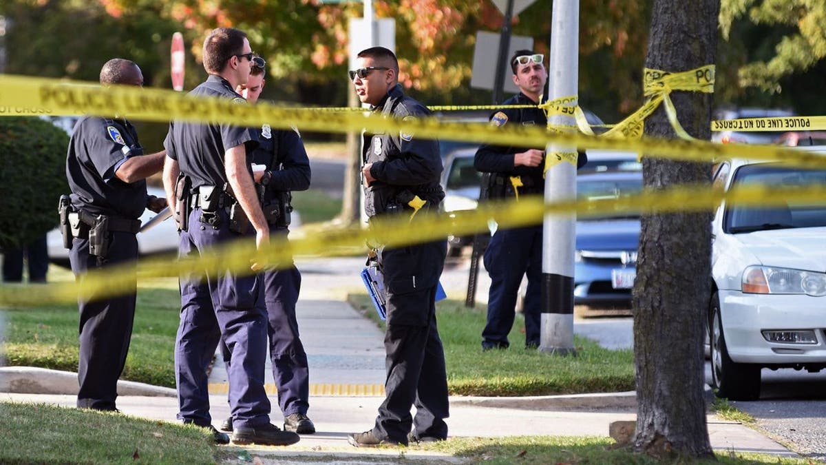 Police at the scene where an infant was in a car that was stolen