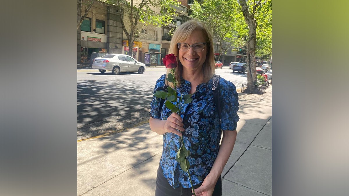 Carol Sbardge holds a flower