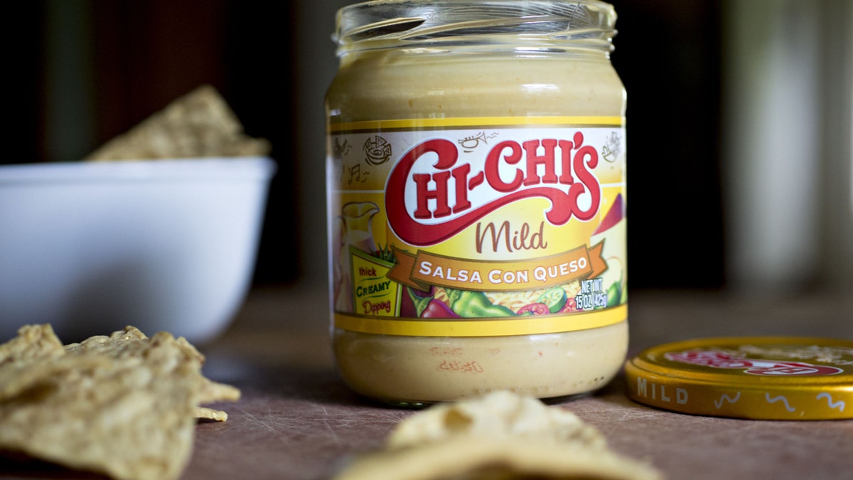 A jar of Chi-Chi's brand salsa con queso is arranged for a photograph.