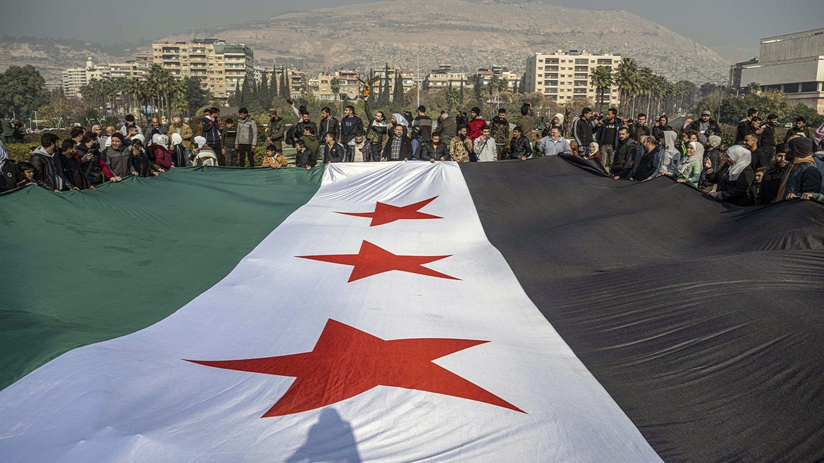 Syrians gather at Umayyad Square to celebrate the collapse of 61 years of Ba'ath Party rule in Damascus, Syria, on December 9, 2024.