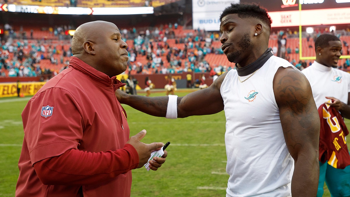 Eric Bieniemy and Tyreek Hill embrace