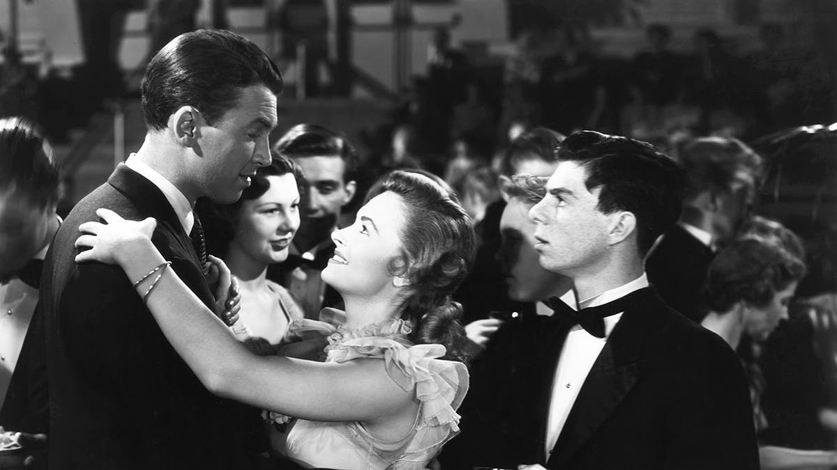 Carl Switzer watches James Stewart dance with Donna Reed in It's a Wonderful Life