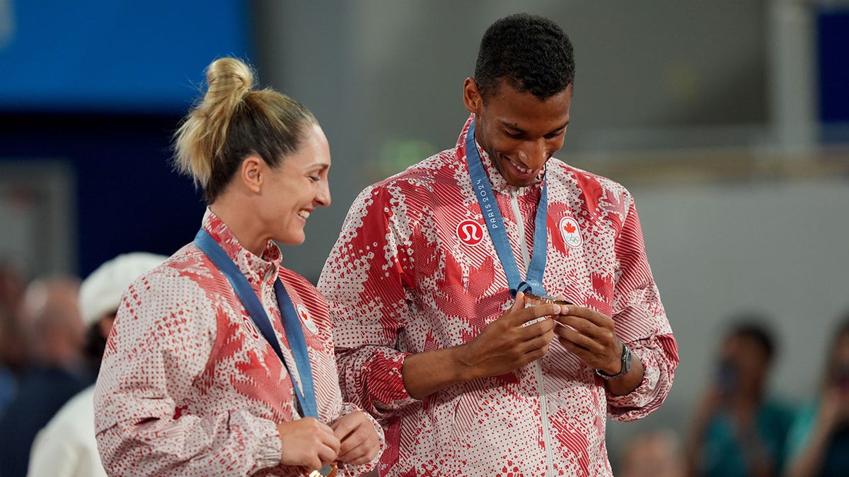 Gabriela Dabrowski and Felix Auger-Aliassime celebrate