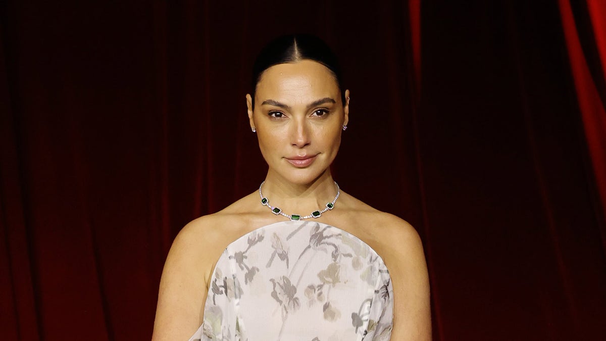 Actress Gal Gadot wears a strapless floral gown.