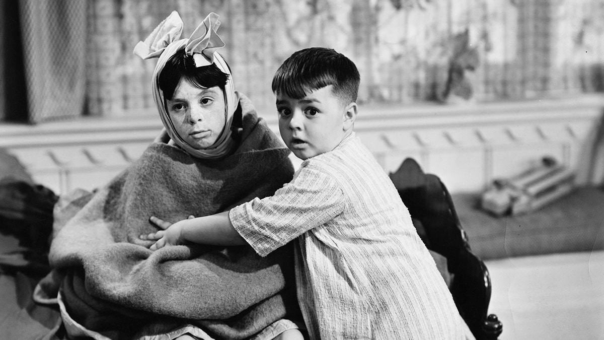 Carl Switzer was wrapped in a blanket and held by his child, who plays Spanky.