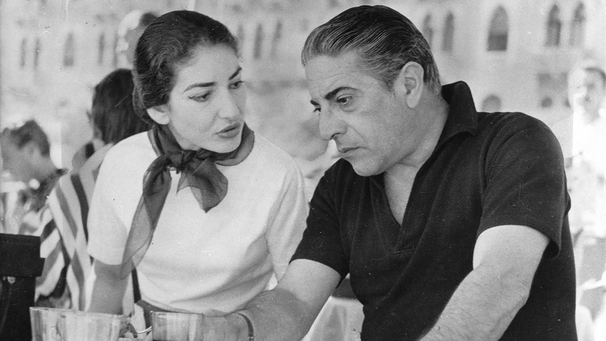 Maria Callas speaks, Aristotle Onassis looks down solemnly