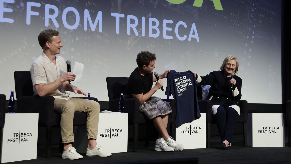 Tommy Vietor, Jon Lovett and Hillary Clinton speak after the "Pod Save America Live" event during the 2023 Tribeca Festival at BMCC Theater on June 12, 2023 in New York City. (Photo by Jason Mendez/Getty Images for Tribeca Festival)