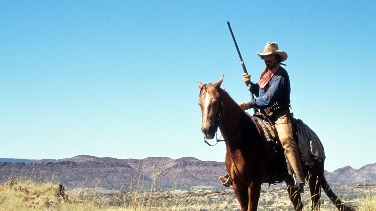 Tom Selleck riding a horse