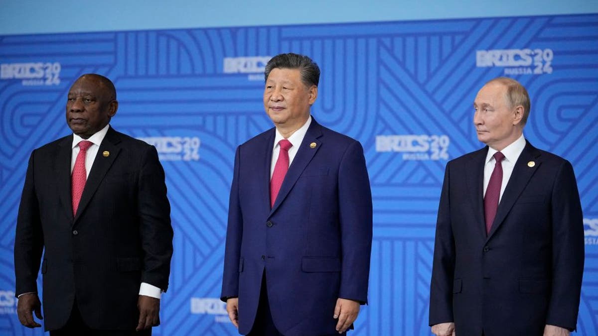 South African President Cyril Ramaphosa, Chinese President Xi Jinping and Russian President Vladimir Putin pose for a family photo during the BRICS summit in Kazan on October 23, 2024.  