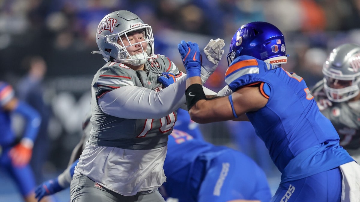 Offensive lineman Mathyus Su'a of the UNLV Rebels and outside linebacker Jayden Virgin-Morgan #5 of the Boise State Broncos battle along the line of scrimmage during the first half of the Mountain West Championship at Albertsons Stadium on December 06, 2024 in Boise, Idaho.