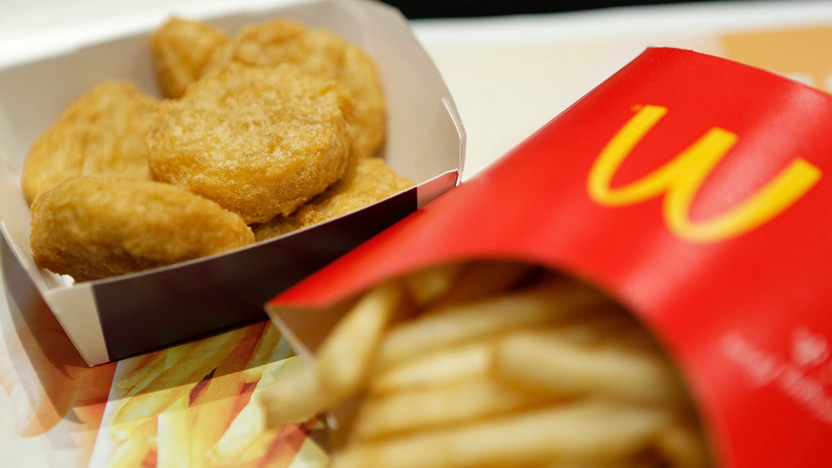 A box of chicken nuggets, left, sits beside a portion of french fries.