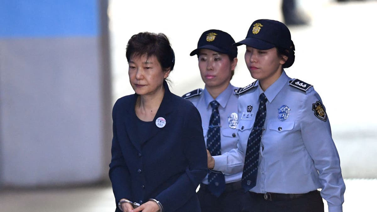 FILE:  South Korean ousted leader Park Geun-Hye (L) arrives at the Seoul Central District Court in Seoul on May 25, 2017, for her trial over the massive corruption scandal that led to her downfall.  