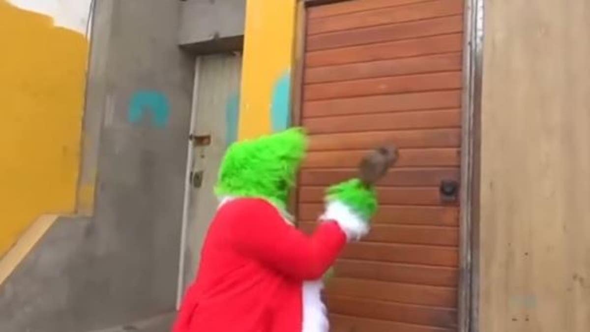 The "Grinch" busting down a door