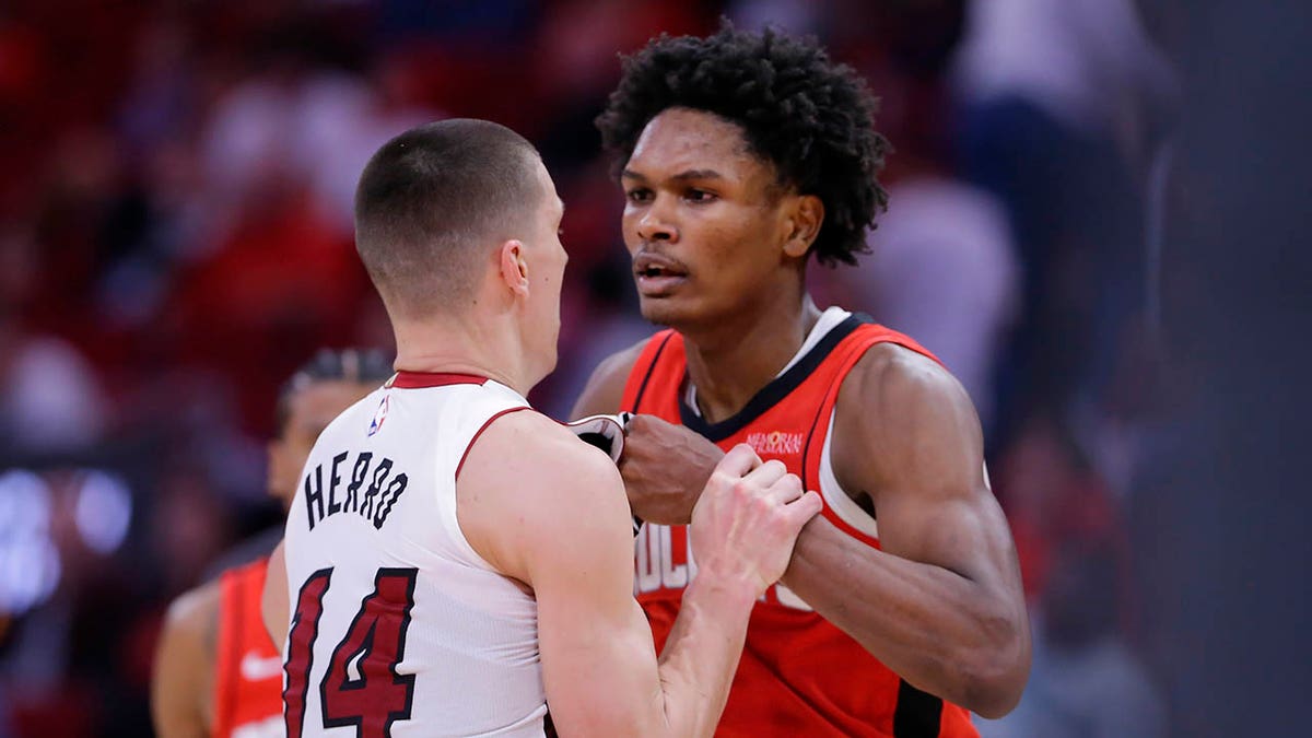 Tyler Herro and Amen Thompson face to face