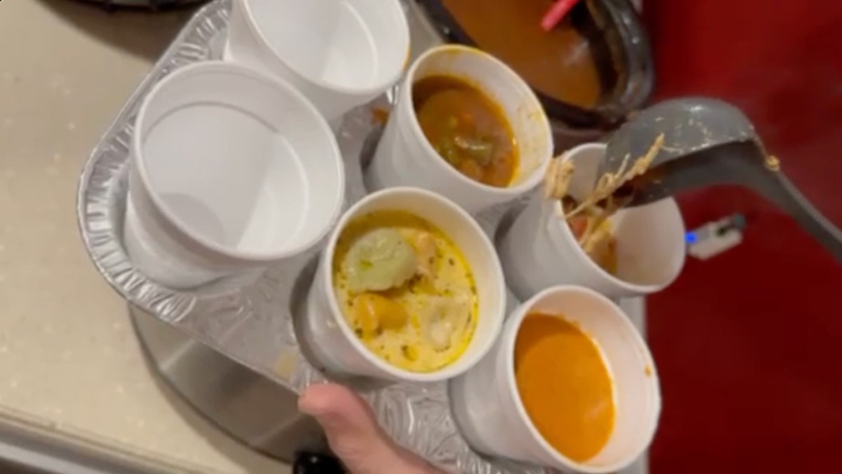 Muffin tins hold cups of soup during a holiday potluck party.