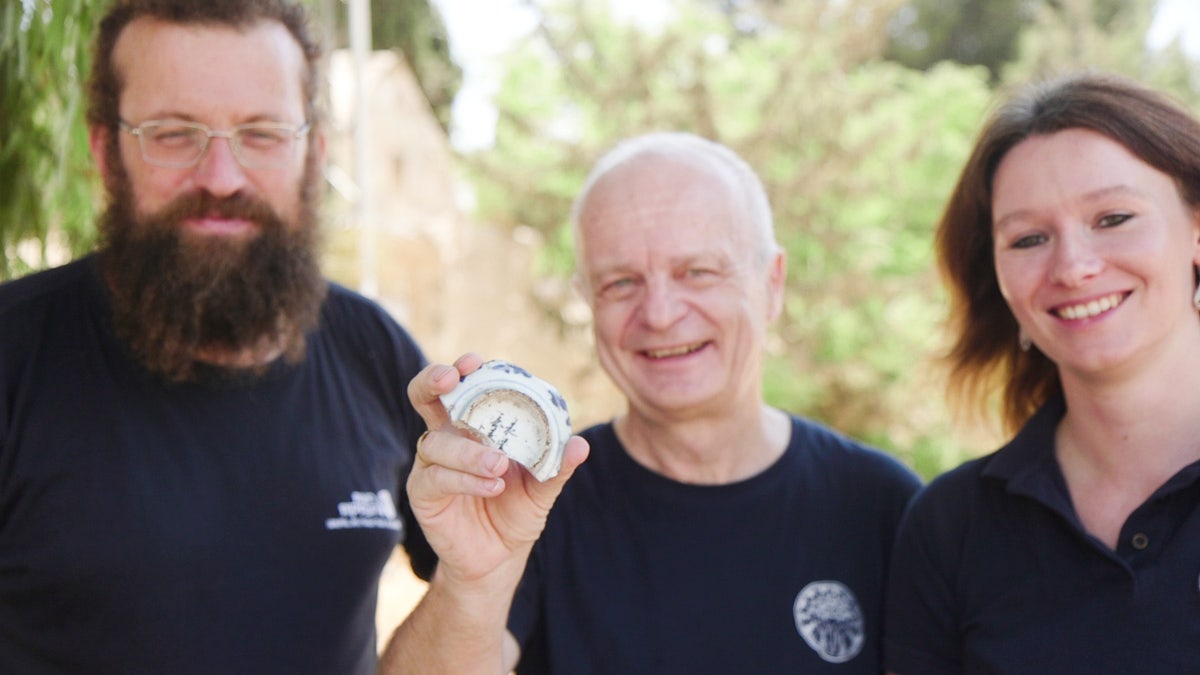 A smiling man holding a bowl