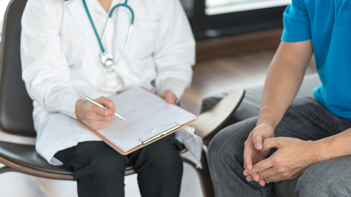 Doctor sitting with a patient