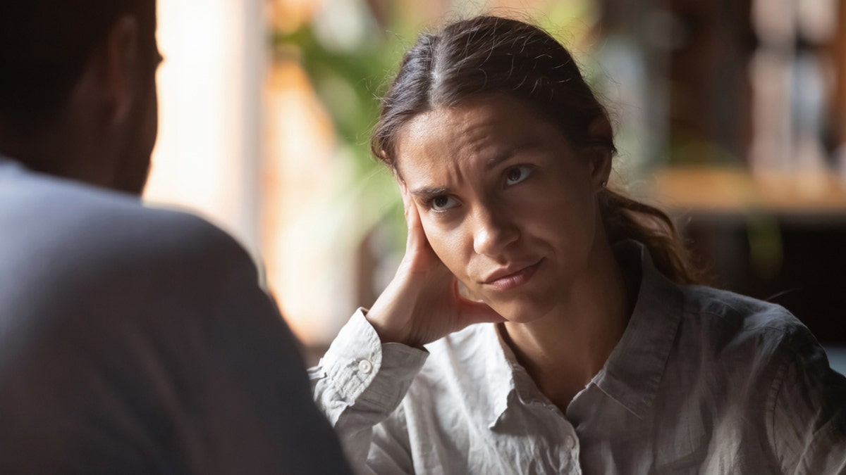 woman looking disgusted in a conversation