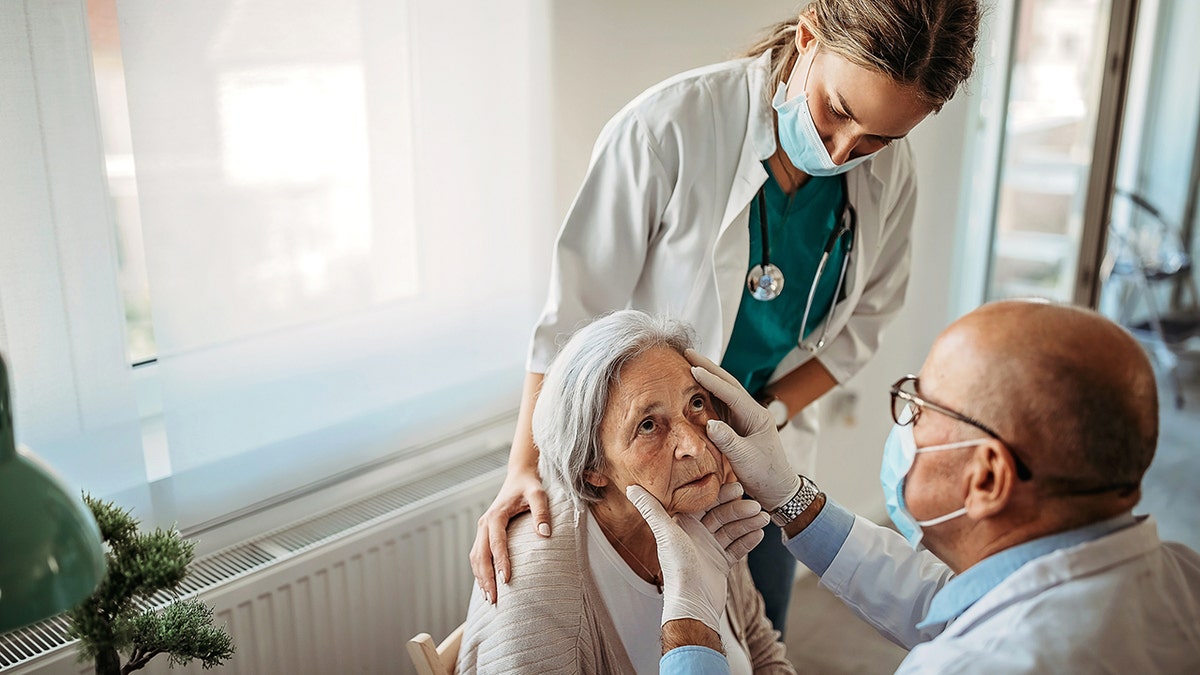 Doctor performs an eye examination on a patient