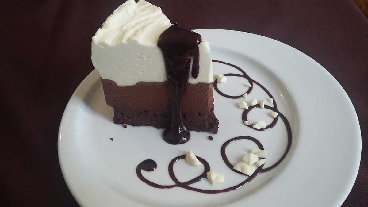 Slice of black tie mousse cake on a plate