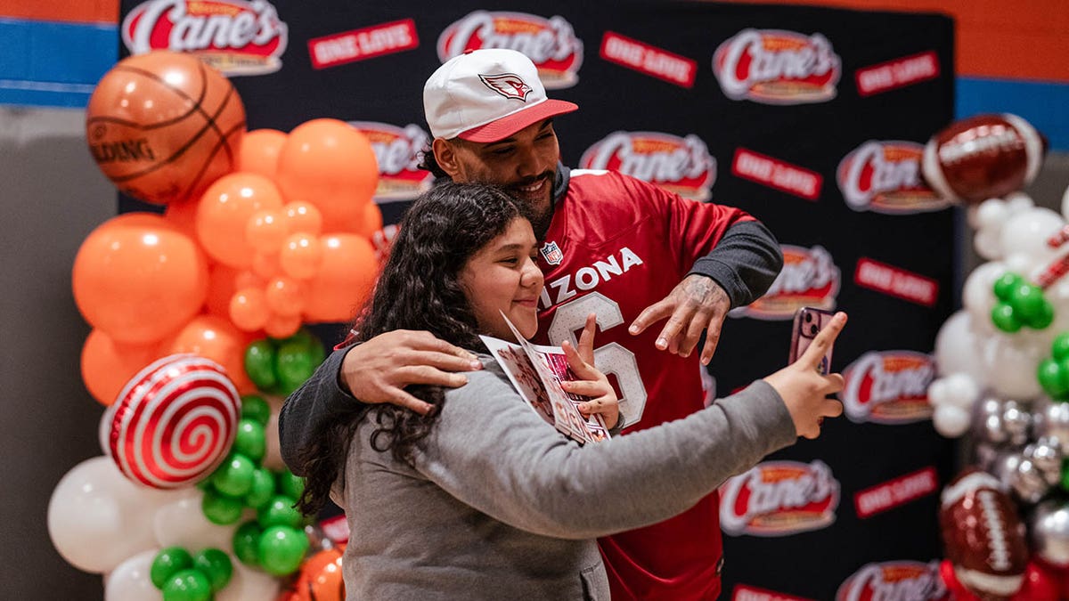 James Conner takes picture with fan