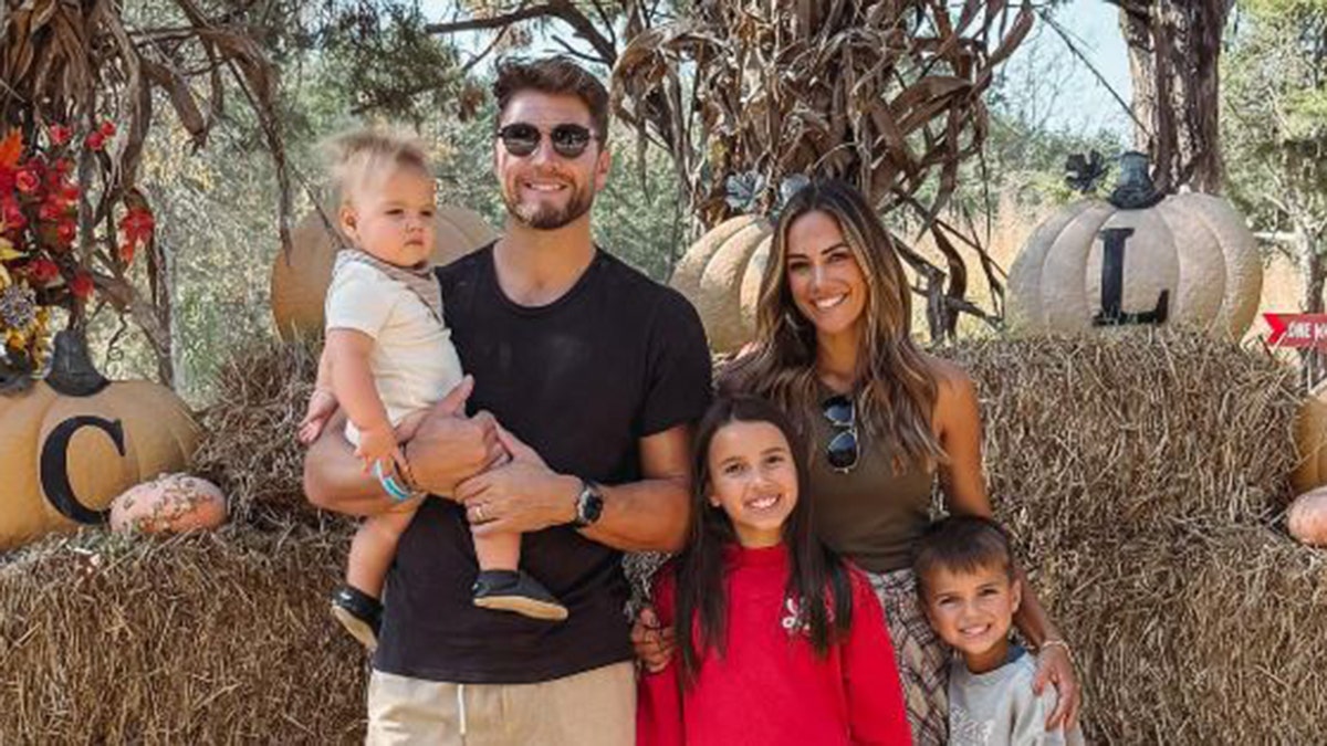 Jana Kramer and Allan Russell with their two children and their one-year-old son