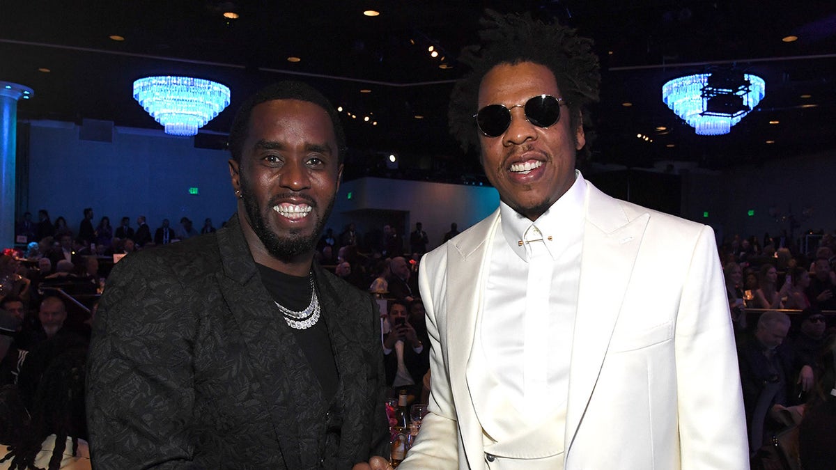 Sean Diddy Combs smiles next to Jay-Z